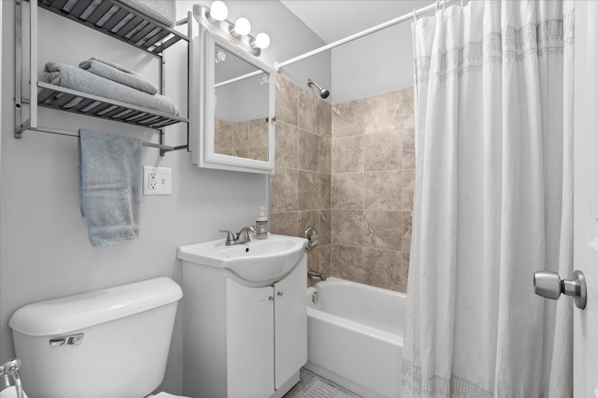 2735 North Ridgeway Avenue Chicago, IL 60647 - Photo 13 of 40 a bathroom with a sink a toilet and shower