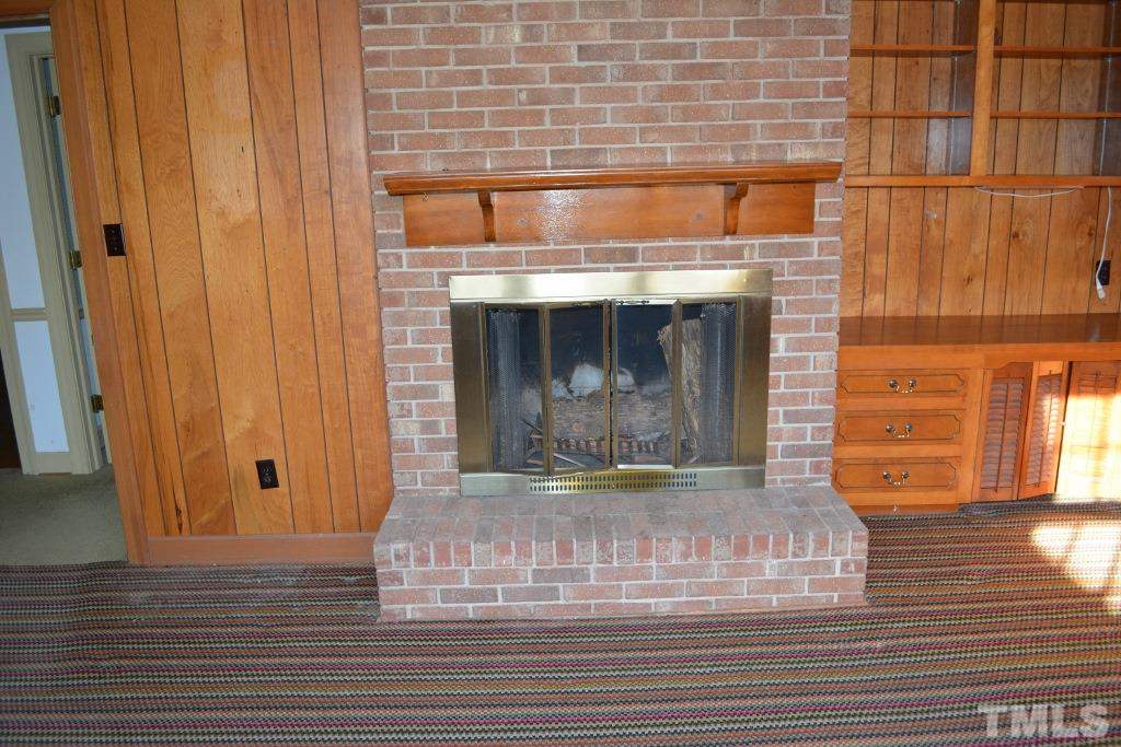 2808 Glen Burnie Drive Raleigh, NC 27607 - Photo 16 of 23 a view of fireplace and wooden floor