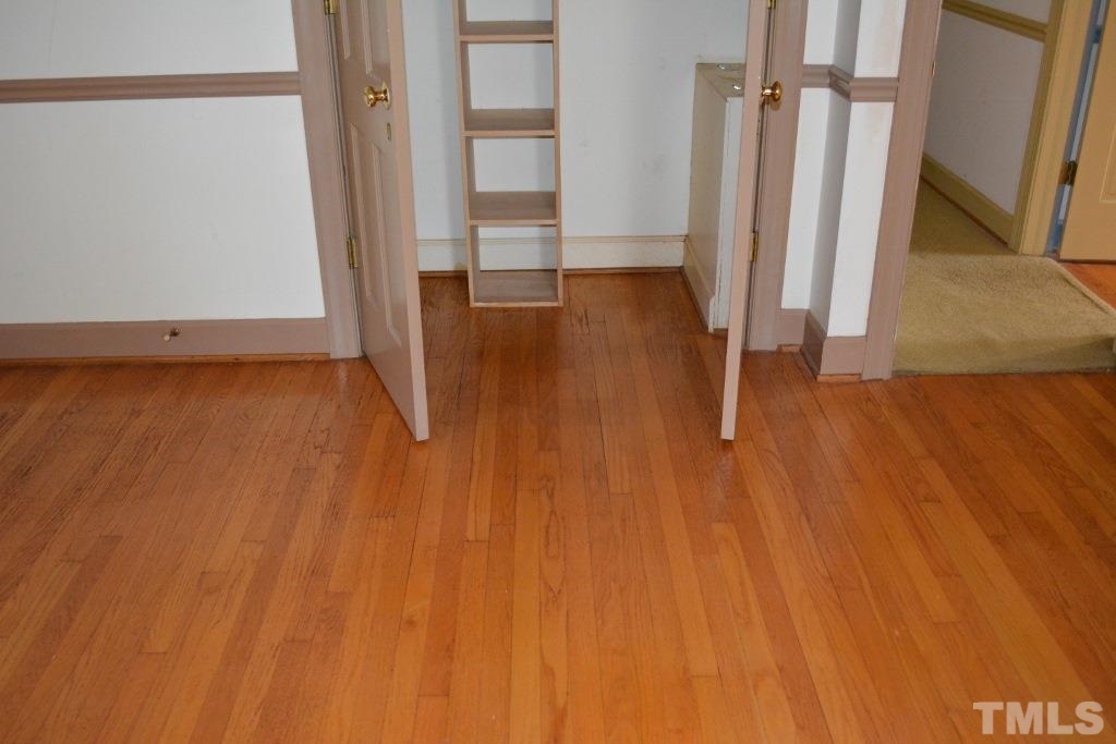 2808 Glen Burnie Drive Raleigh, NC 27607 - Photo 17 of 23 an empty room with wooden floor and entrance