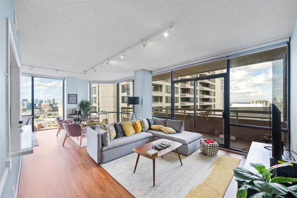 a living room with furniture and a floor to ceiling window