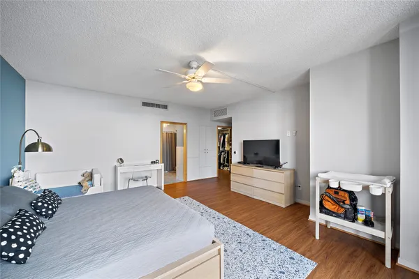 a bedroom with furniture and a flat screen tv