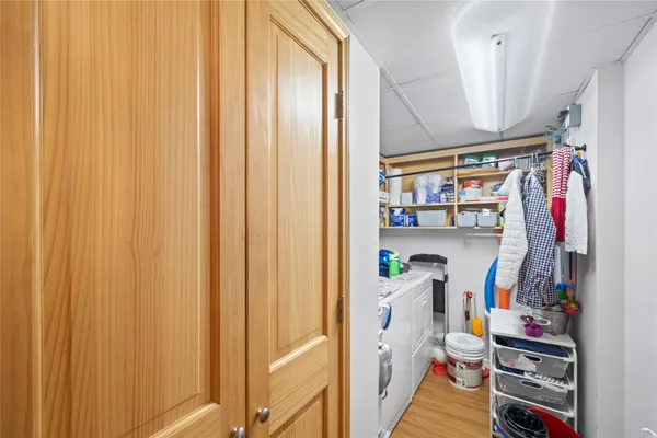 a view of walk in closet with clothes and shoes