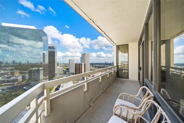 a view of a balcony with chairs