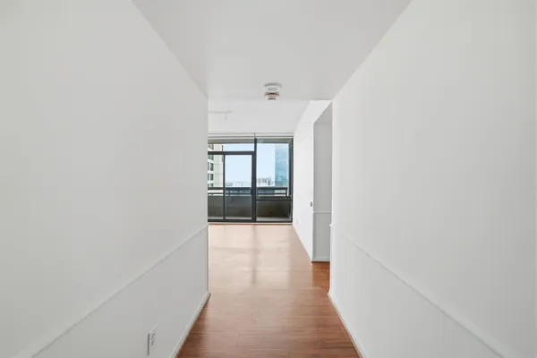 a view of hallway with wooden floor