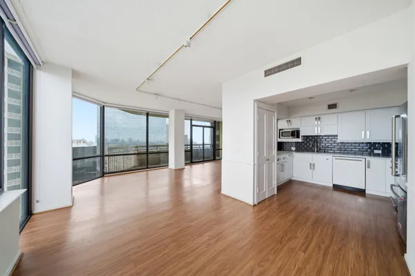a kitchen with white cabinets and stainless steel appliances