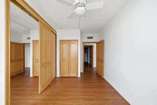 a view of a hallway with wooden floor
