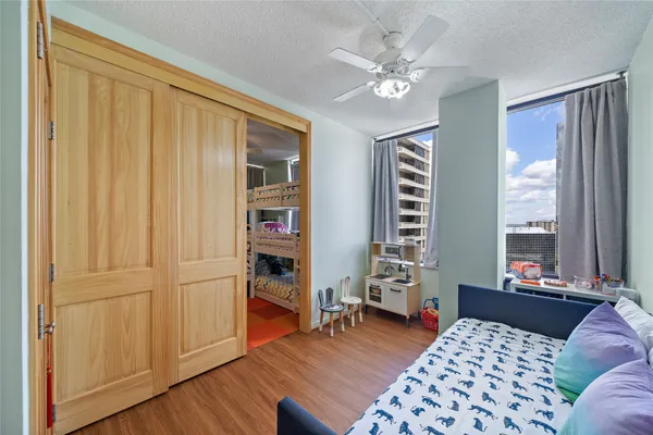 a bedroom with furniture and wooden floor