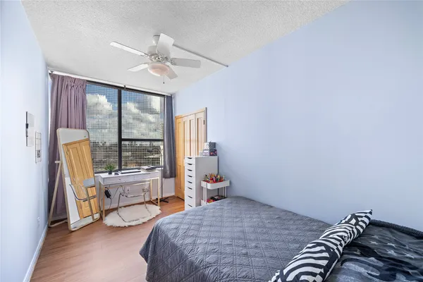 a bedroom with a bed and a large window