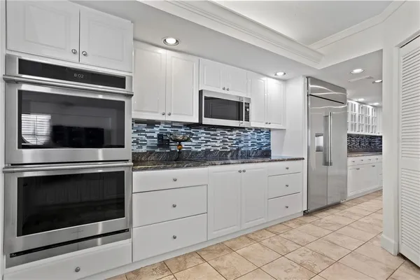 a kitchen with stainless steel appliances granite countertop a sink and cabinets
