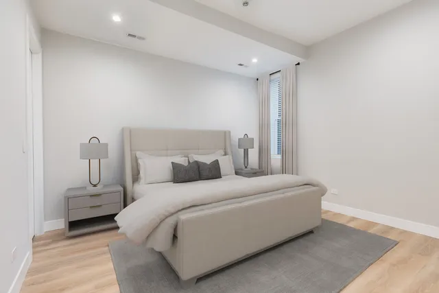 a bedroom with a bed and a night stand