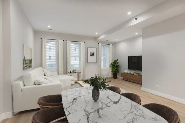 a living room with furniture potted plant and a window