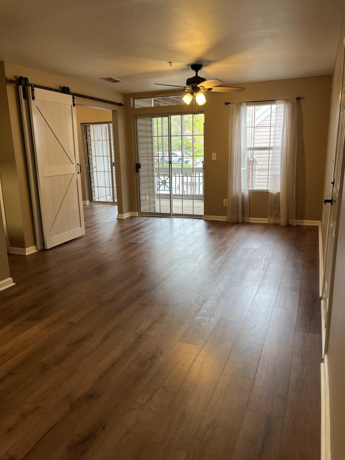 296 Canterbury Road, Unit 296J Bel Air, MD 21014 - Photo 5 of 13 an empty room with wooden floor and windows