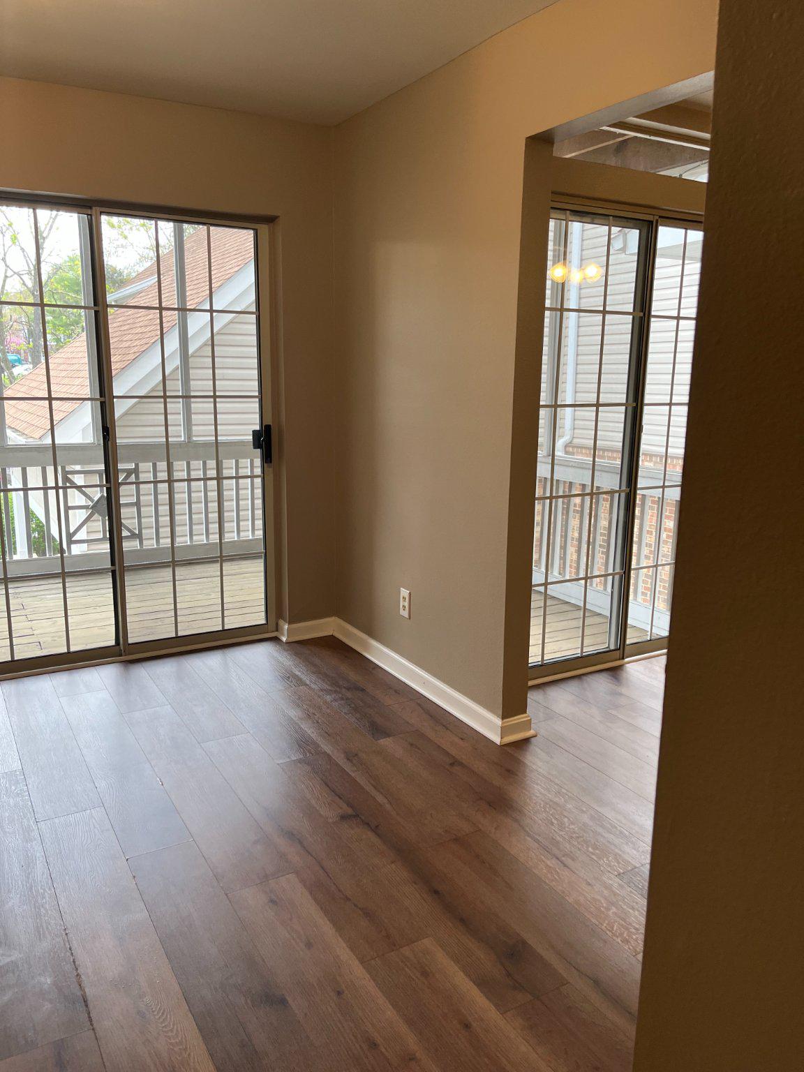 296 Canterbury Road, Unit 296J Bel Air, MD 21014 - Photo 9 of 13 an empty room with wooden floor and windows