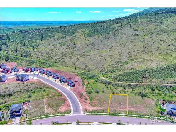 an aerial view of a houses with a yard