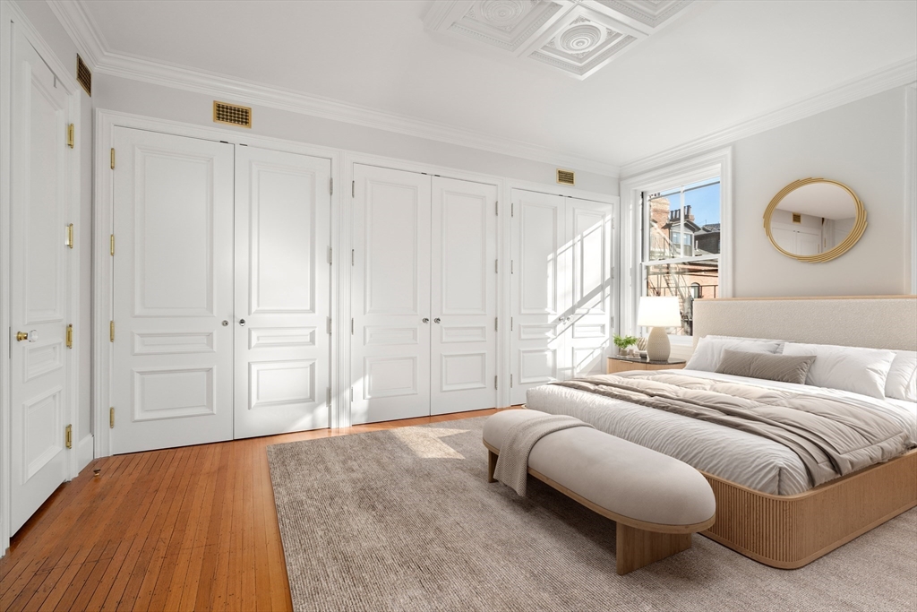 357-359 Beacon Street, Unit 4 Boston, MA 02116 - Photo 6 of 12 a bedroom with a large bed and a chandelier