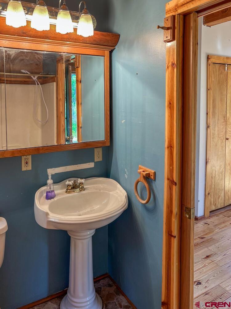 454 Estates Circle Road Pagosa Springs, CO 81147 - Photo 13 of 35 a bathroom with a sink and a mirror