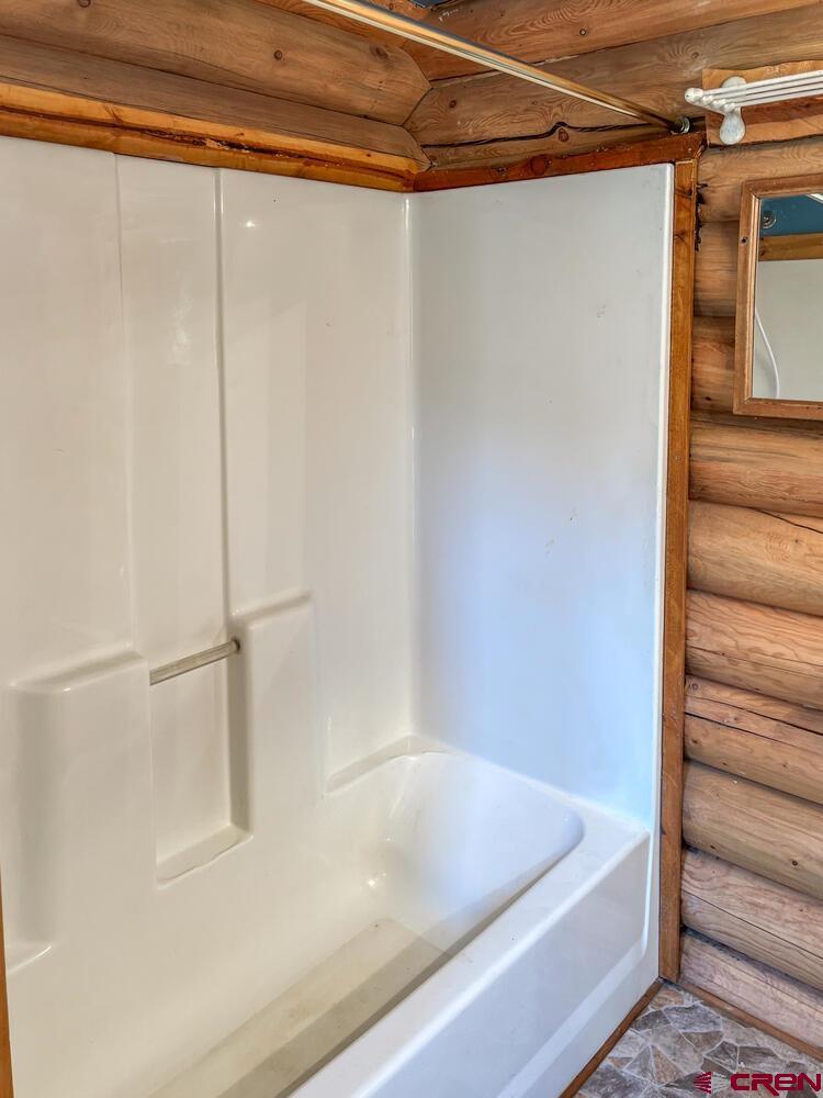 454 Estates Circle Road Pagosa Springs, CO 81147 - Photo 14 of 35 a bathroom with a shower and a bath tub