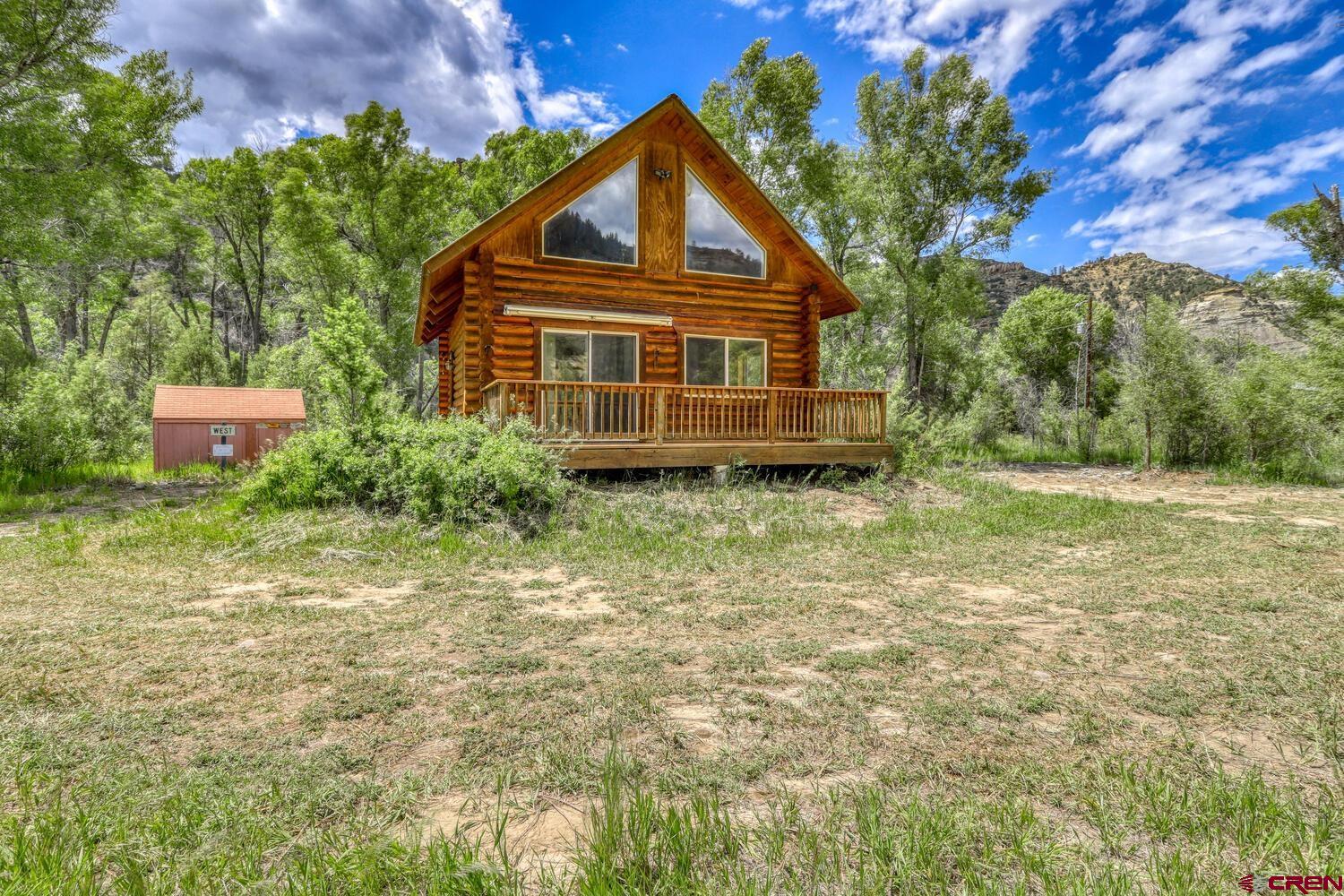 454 Estates Circle Road Pagosa Springs, CO 81147 - Photo 26 of 35 a front view of a house with a yard