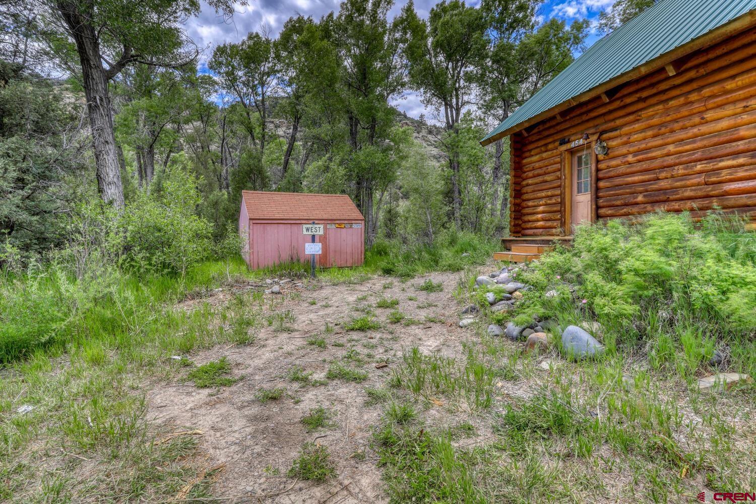 454 Estates Circle Road Pagosa Springs, CO 81147 - Photo 27 of 35 a backyard of a house with lots of green space
