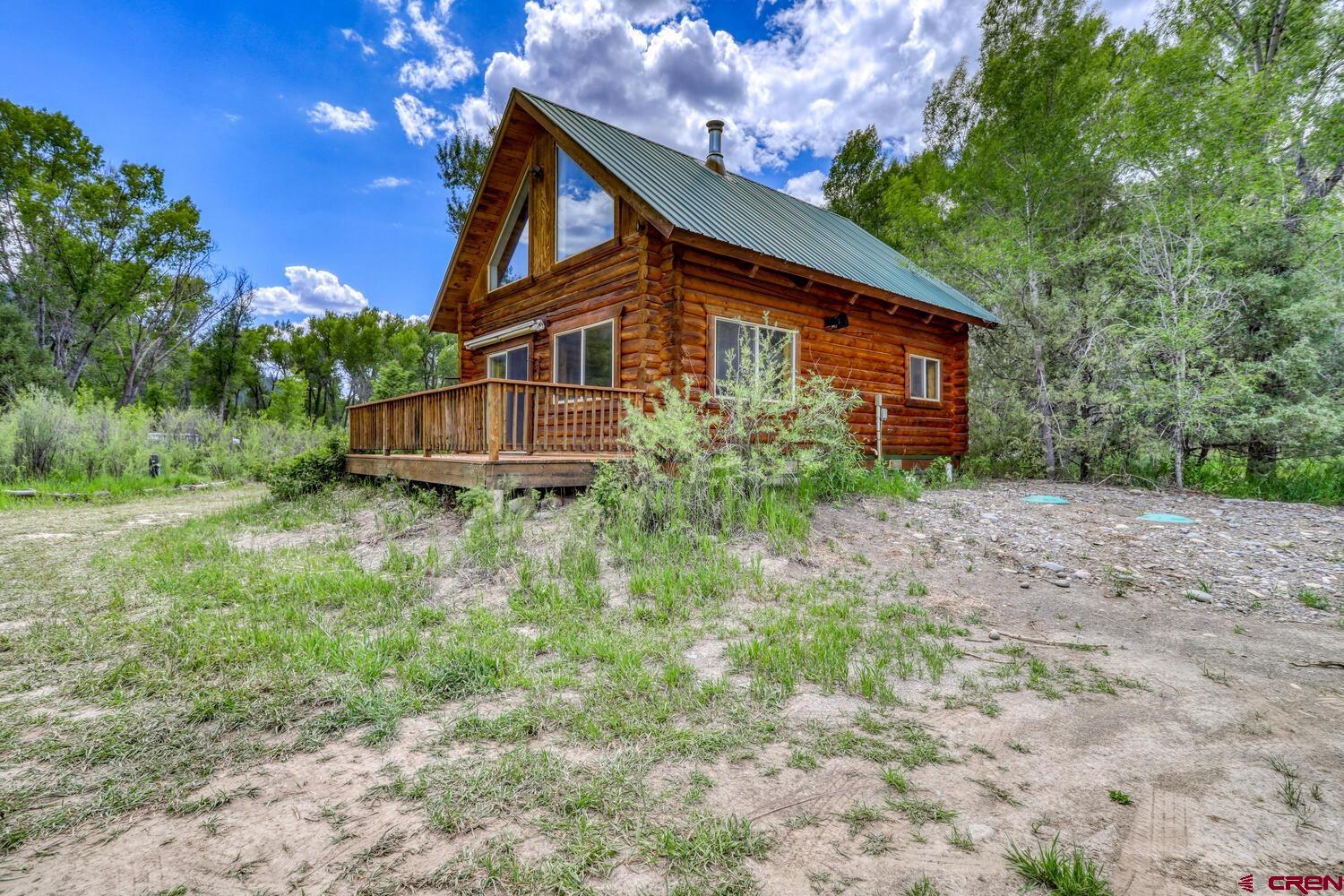 454 Estates Circle Road Pagosa Springs, CO 81147 - Photo 29 of 35 a backyard of a house with lots of green space