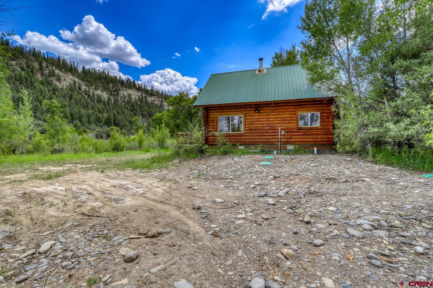 454 Estates Circle Road Pagosa Springs, CO 81147 - Photo 30 of 35 a view of a house with a yard