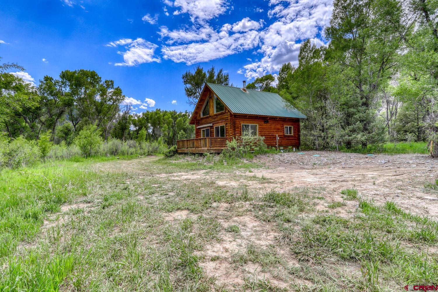 454 Estates Circle Road Pagosa Springs, CO 81147 - Photo 31 of 35 a front view of a house with a yard