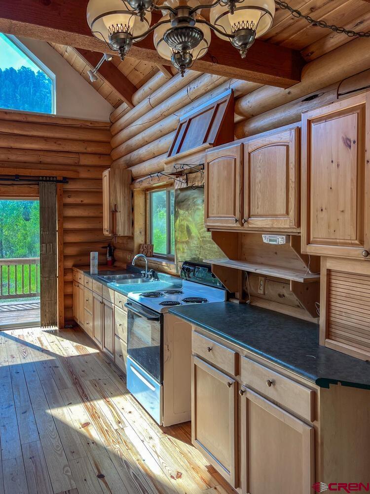 454 Estates Circle Road Pagosa Springs, CO 81147 - Photo 8 of 35 a kitchen with granite countertop lots of counter top space and wooden floor