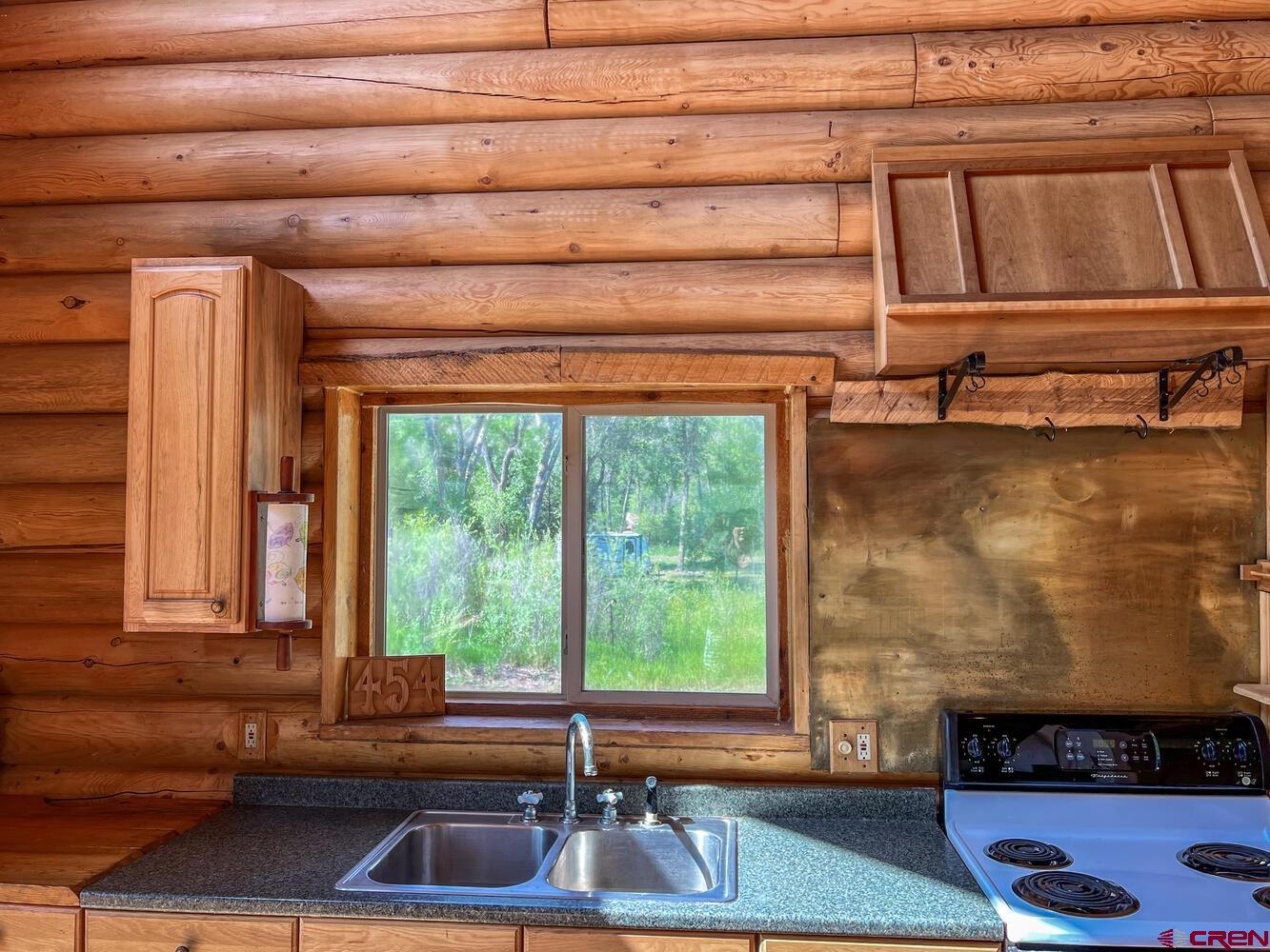 454 Estates Circle Road Pagosa Springs, CO 81147 - Photo 9 of 35 a kitchen with a sink and a window