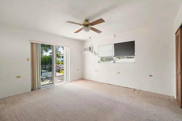 a view of empty room with ceiling fan