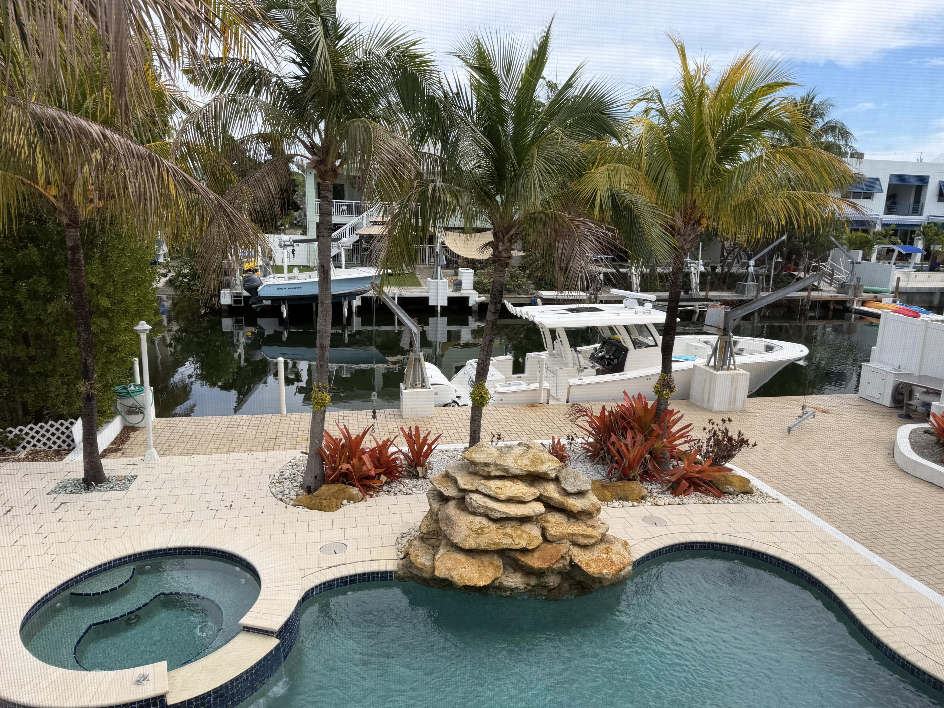 234 Mohawk Street Tavernier, FL 33070 - Photo 2 of 61 a swimming pool with outdoor seating and yard