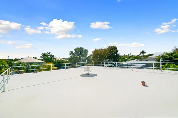 a view of a swimming pool with a patio and a yard