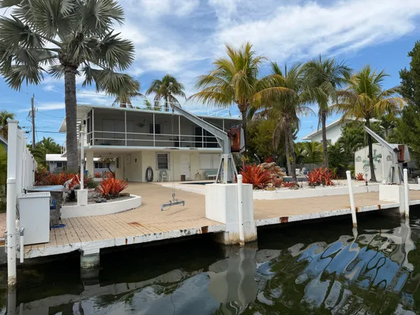 an aerial view of residential houses with outdoor space and swimming pool