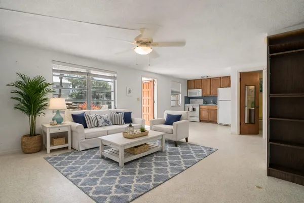 an aerial view of residential houses with outdoor space and swimming pool