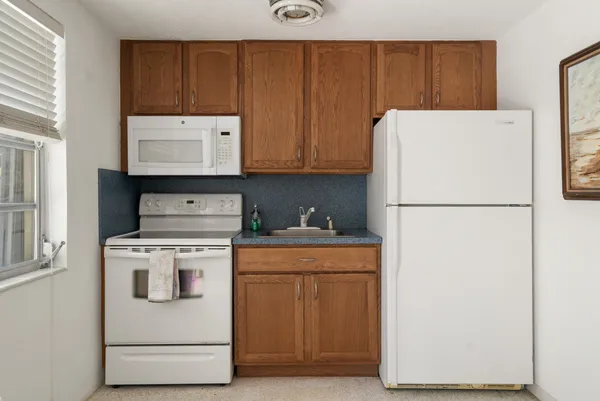a view of a lake with couches and wooden fence