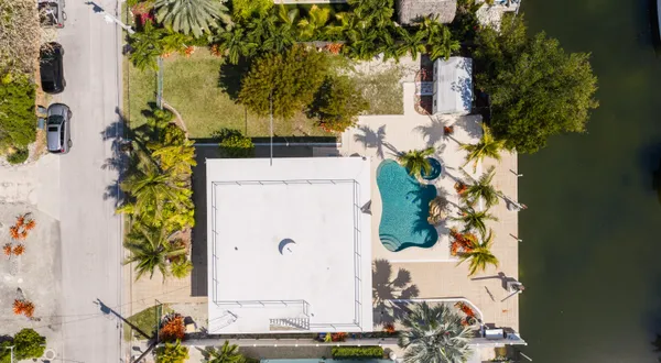 an aerial view of a house with a yard and garden