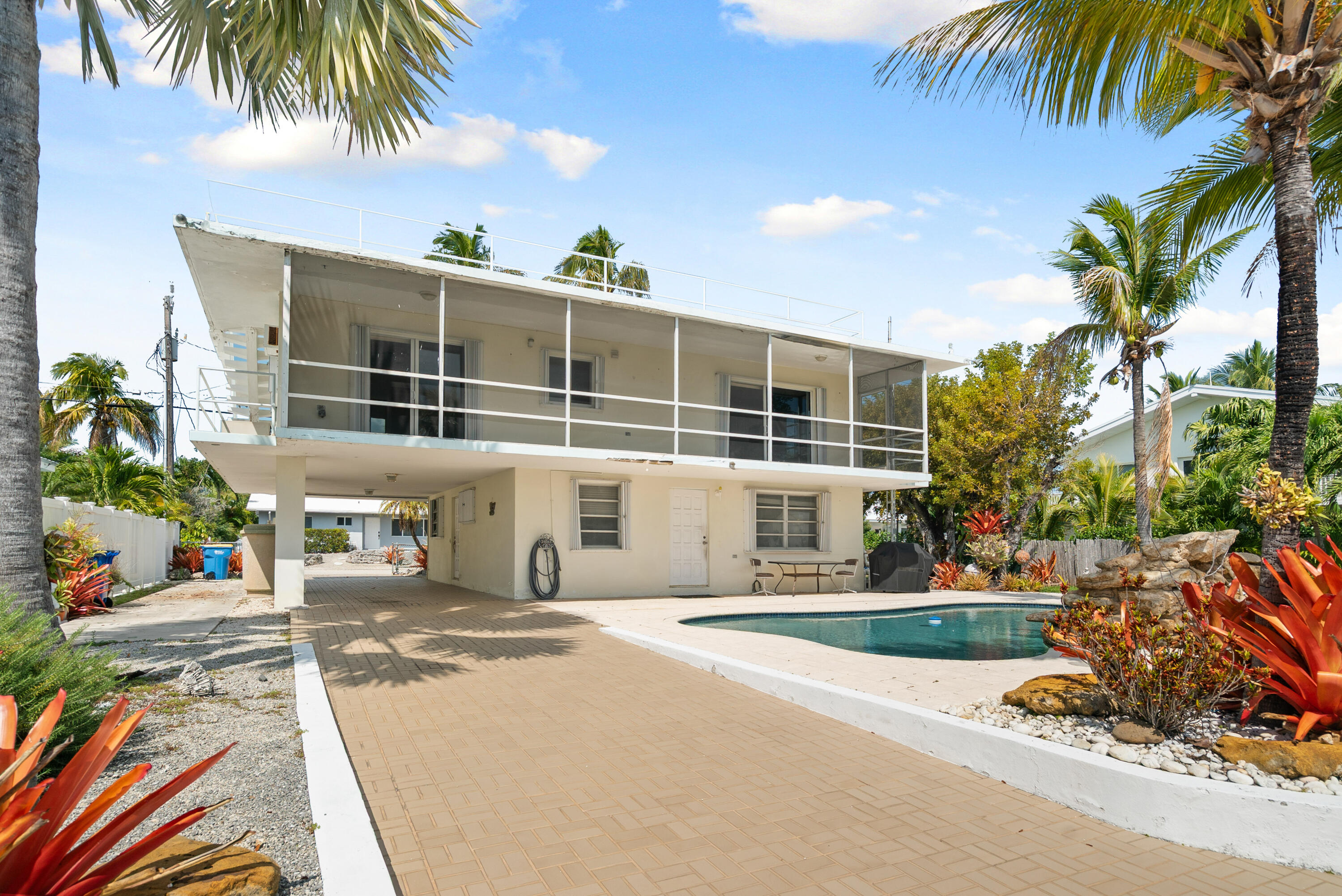 234 Mohawk Street Tavernier, FL 33070 - Photo 52 of 61 a house with palm tree in front of it