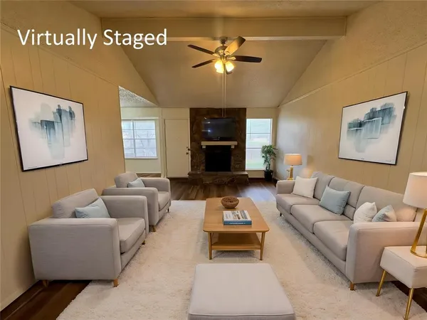 a living room with furniture and a ceiling fan