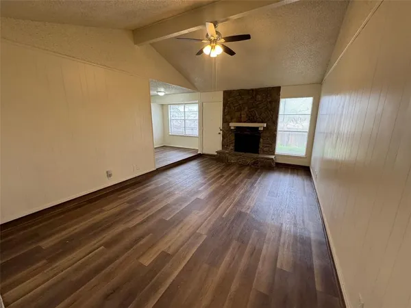 wooden floor in an empty room with a fireplace