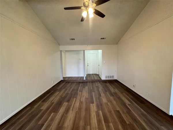 a view of an empty room and wooden floor