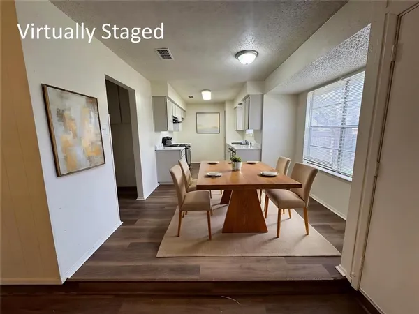 a view of a dining room with furniture and a window