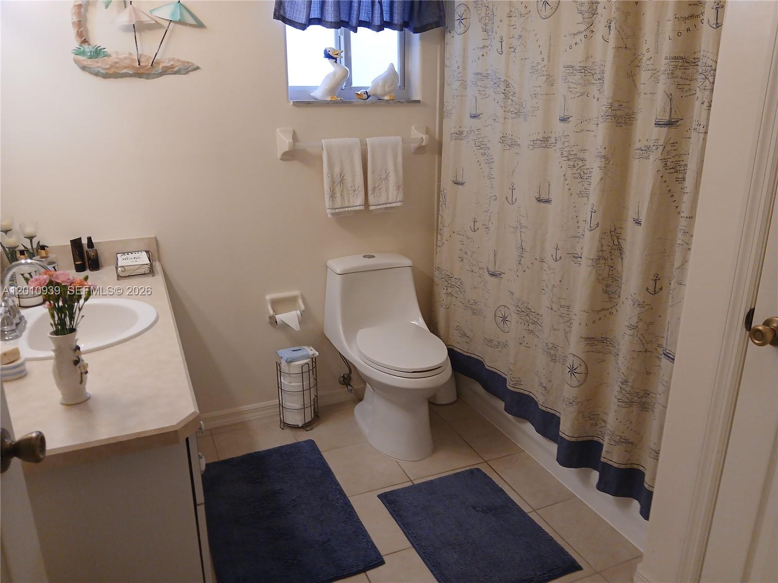 5880 Southwest 102nd Street Ocala, FL 34476 - Photo 13 of 17 a white toilet sitting next to a bathroom sink