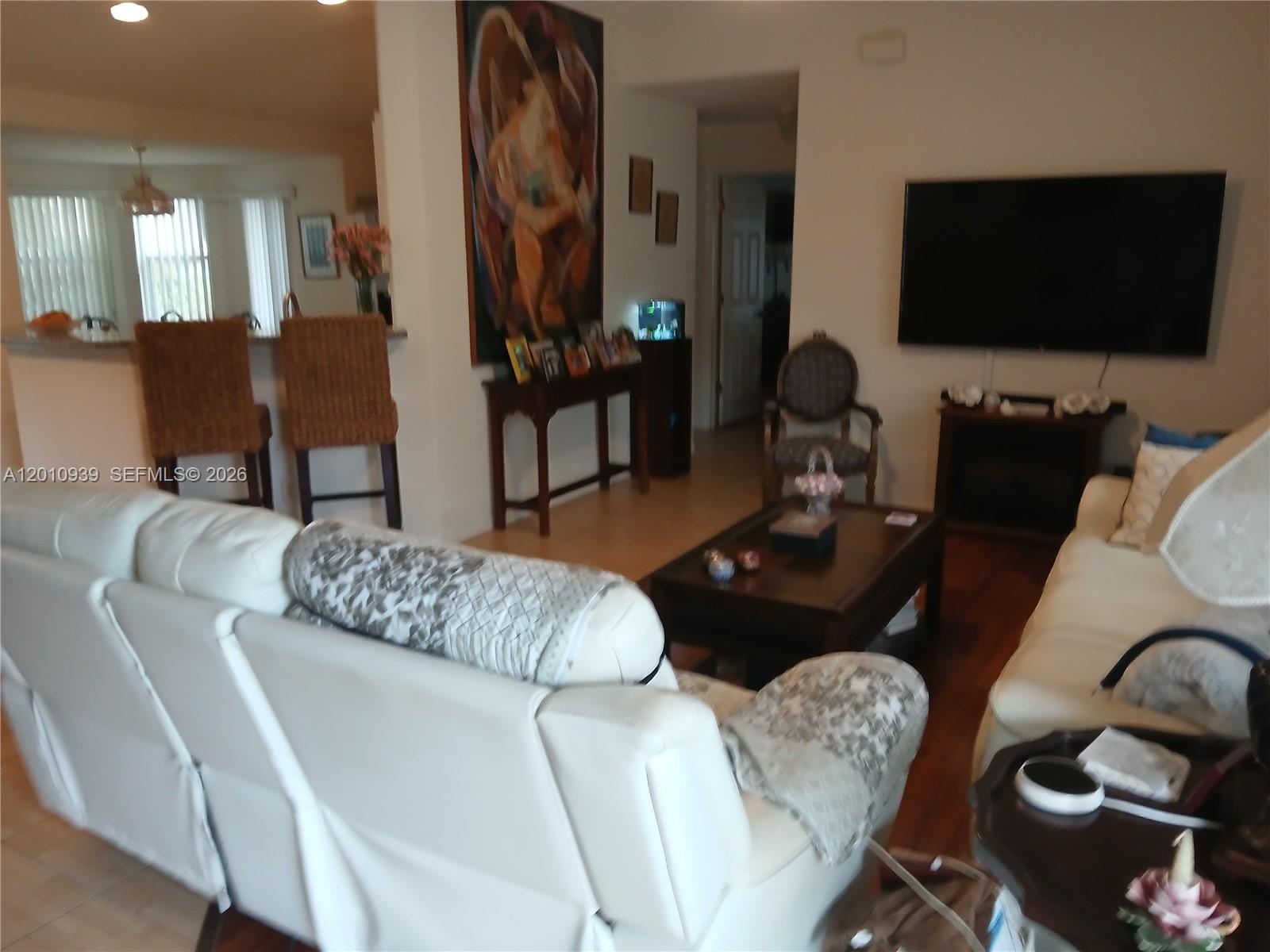 5880 Southwest 102nd Street Ocala, FL 34476 - Photo 3 of 17 a living room with furniture and a flat screen tv