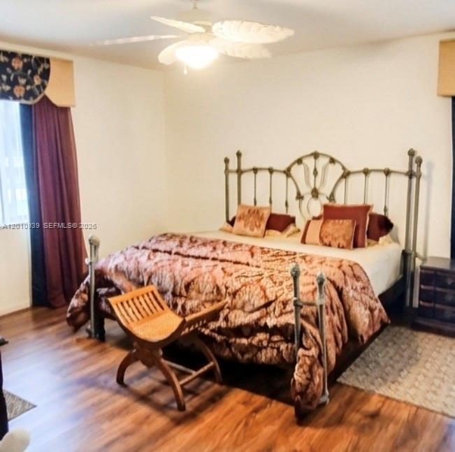 5880 Southwest 102nd Street Ocala, FL 34476 - Photo 9 of 17 a bedroom with a bed and wooden floor