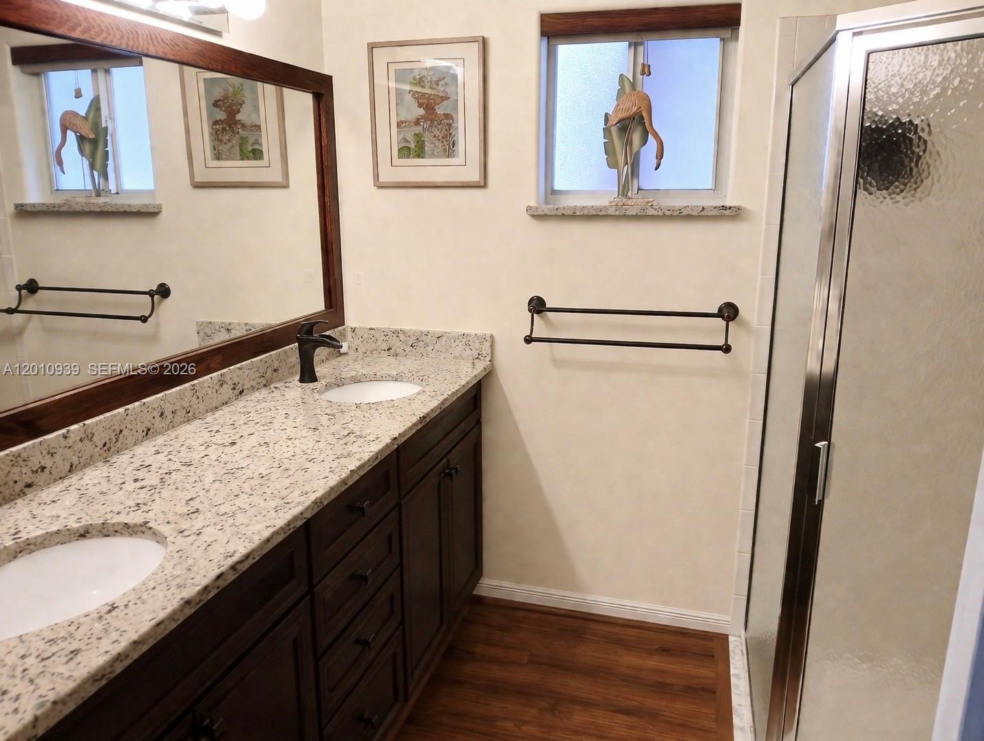 5880 Southwest 102nd Street Ocala, FL 34476 - Photo 10 of 17 a bathroom with a granite countertop double vanity sink and a mirror