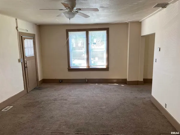 an empty room with closet area