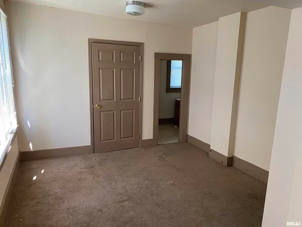 a kitchen with a stove sink and cabinets