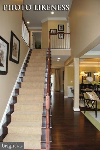 4233 Forge Road Perry Hall, MD 21128 - Photo 3 of 28 a view of staircase with lots of frames and a rug