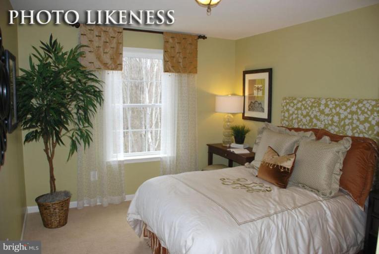 4233 Forge Road Perry Hall, MD 21128 - Photo 21 of 28 a bedroom with a bed and a potted plant