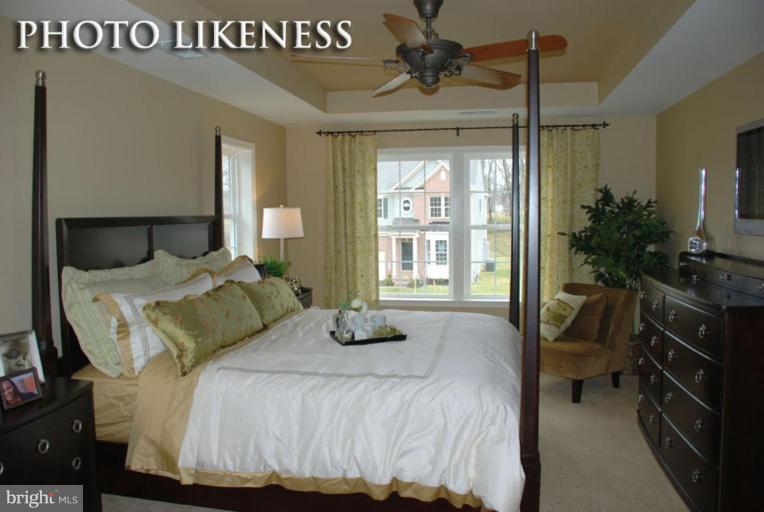 4233 Forge Road Perry Hall, MD 21128 - Photo 22 of 28 a bedroom with a large bed and a chandelier
