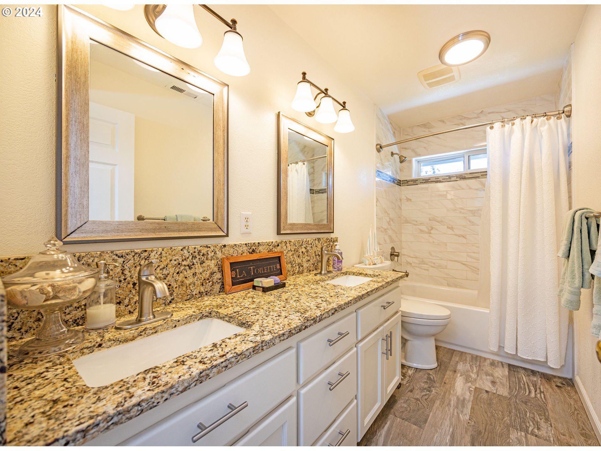 37232 Wallace Creek Road Springfield, OR 97478 - Photo 17 of 45 a bathroom with a granite countertop double vanity sink a mirror and a bathtub